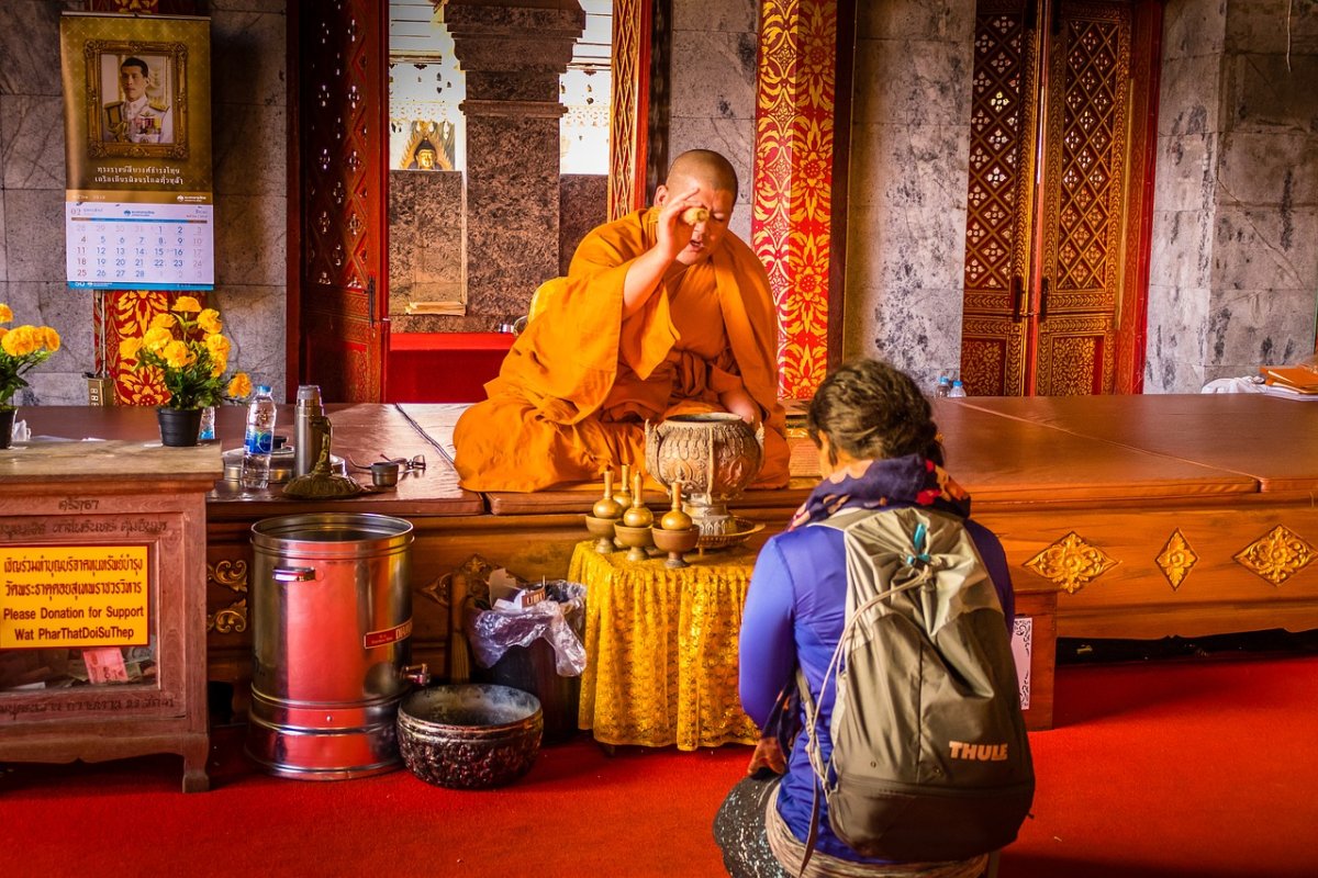 Thailand monk with a foreigner praying in a Thailand Temple Monastery